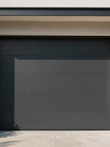 Straight-on architectural shot of a modern dark charcoal garage door integrated into a minimalist home facade, sharp natural daylight casting clean geometric shadows.