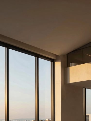 Elegant editorial photography of a modern luxury apartment interior in Usaquén, warm golden-hour sunlight streaming through floor-to-ceiling windows, highlighting clean architectural lines and rich textures, 35mm.