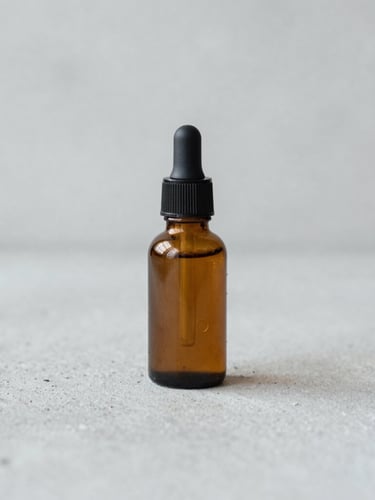 Straight-on eye-level portrait of a minimal amber serum bottle on a raw light grey concrete surface, soft diffused daylight, macro depth of field, 35mm