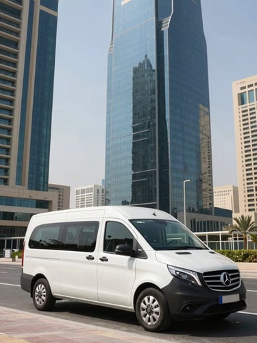 Wide environmental shot of a spotless branded modern moving van parked outside a sleek high-rise tower in Jumeirah Village Triangle, bright desert daylight reflecting off glass facades.