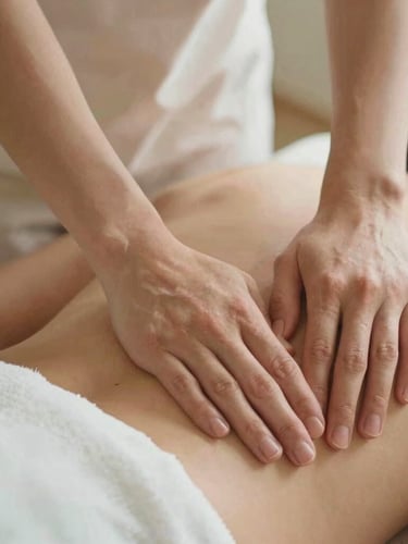 Close-up of therapeutic hands performing gentle bodywork, soft diffused natural daylight, clean linen texture, warm sand tones, shallow depth of field, 35mm