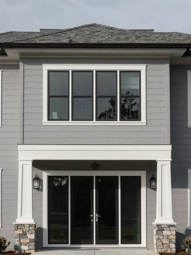 Architectural elevation of a modern residential property in North Carolina, sharp morning daylight, high-contrast desaturated gray tones, crisp framing visible, 35mm lens.