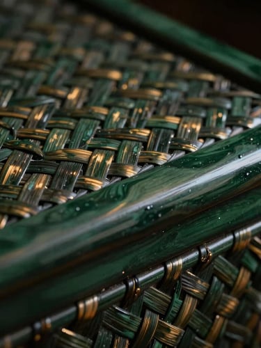 Close-up of hand-woven bamboo texture beside a sleek dark green lacquer surface, warm metallic glints, dramatic low-key lighting, rich shadows, premium craftsmanship
