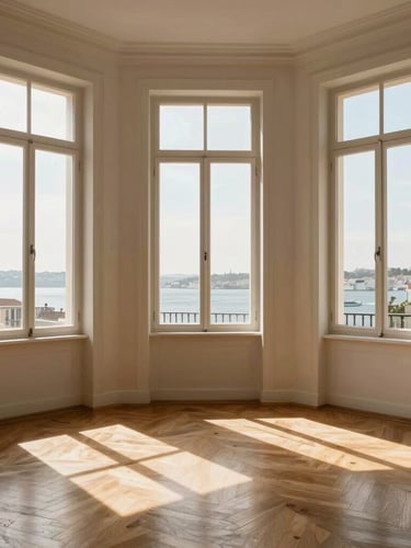 Wide architectural crop of a sun-drenched Lisbon apartment interior, tall Pombaline windows with warm afternoon sunlight streaming across wooden floors, minimalist design, high dynamic range.