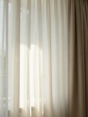 Bright editorial close-up of a beautifully designed staycation apartment interior at Shore Residences Pasay, soft ambient sunlight filtering through curtains.