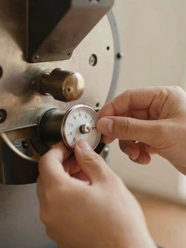Close-up of hands adjusting the dial of a premium coffee roaster, soft morning light, warm parchment tones, editorial photography