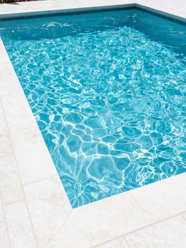 Bright high-key photography of a sparkling residential pool in Orlando, crisp midday Florida sunlight, clean white stone deck, vibrant blue water ripples, 35mm