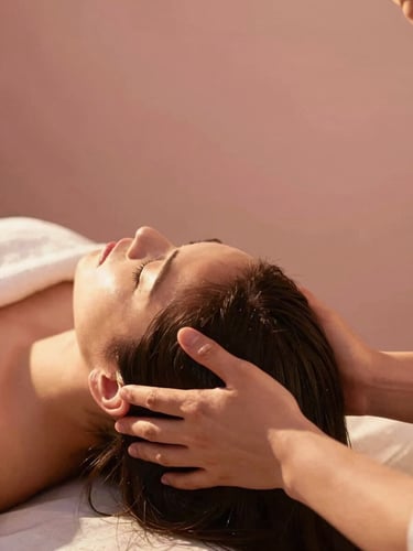 Candid shot of a therapist performing a relaxing scalp massage, soft warm background, cinematic sunlight, focus on hands and serene expression