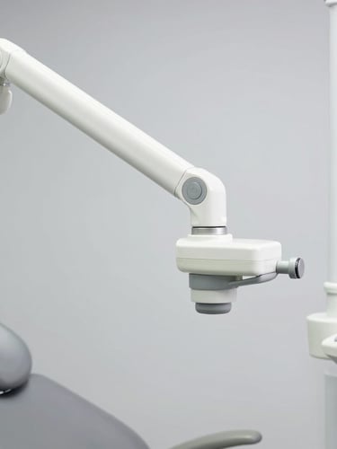 Crisp high-resolution studio photo of a modern dental operatory chair hydraulic arm mechanism, clean sterile gray background
