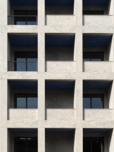 Crisp architectural photography of a modern structured concrete building with sharp shadows, bright natural daylight, deep navy and clean cream tones, 35mm