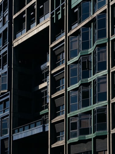 Architectural detail of the Colombian Supreme Court building in Bogotá, sharp high-contrast morning light, deep shadows, 35mm lens
