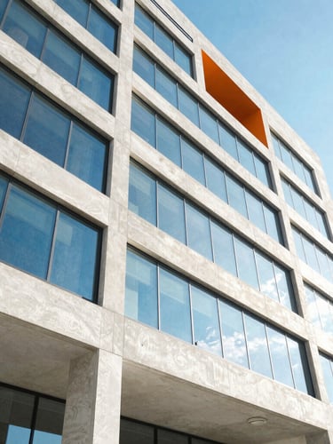 Wide-angle architectural crop of a modern concrete and glass building facade in Tampa under bright high-key natural daylight, sharp shadows, electric blue sky reflection