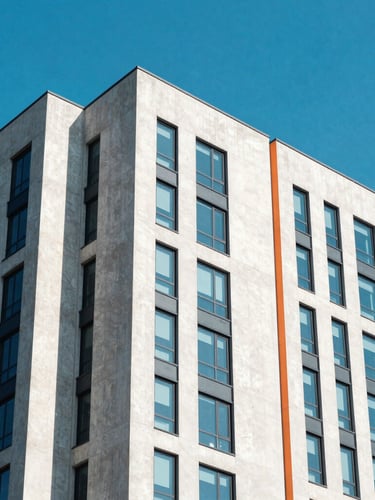 Bright architectural photography of high-altitude concrete and glass skyscraper corners under high-key natural daylight, sharp shadows, electric blue skies
