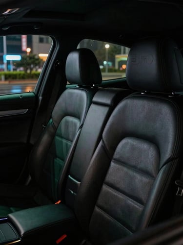 Cinematic close-up of a clean black leather interior of a premium sedan, soft green dashboard glow, nighttime urban reflections on the side window