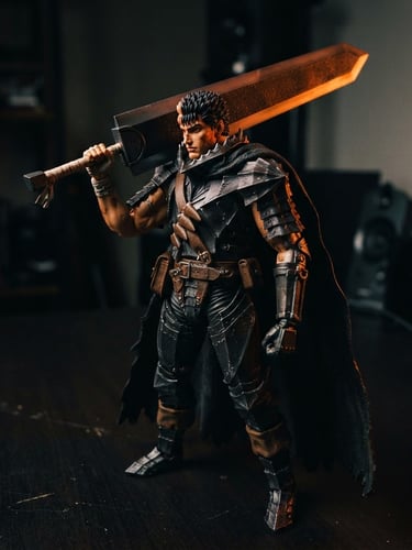 Dramatic close-up of a premium anime action figure on a clean dark desk, vibrant orange rim lighting, moody high contrast shadows, 35mm photography