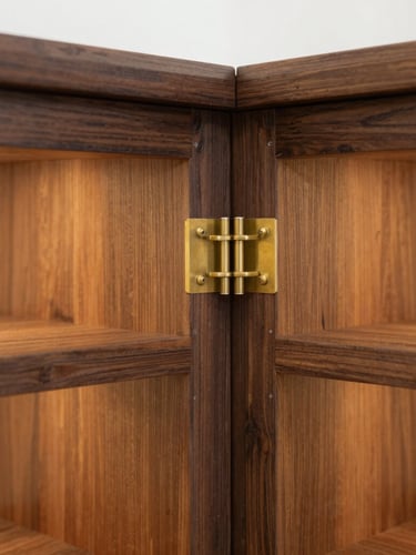Close-up macro shot of a custom dark oak cabinet junction with brass fittings, warm interior lighting, architectural precision