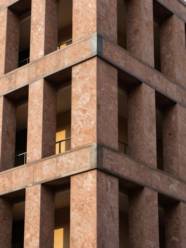 Architectural facade detail under bright Lagos sunlight, sharp metal-to-stone junctions, professional architectural photography