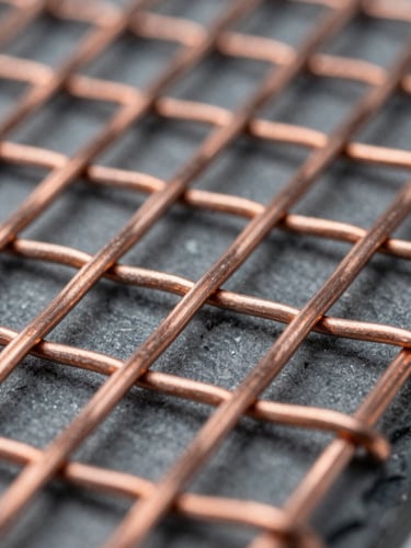 Extreme macro detail of laminated woven copper wire mesh, cool diffused laboratory light, sharp focus on metallic texture, slate and steel tones, 50mm lens.