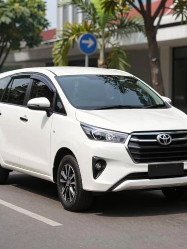 Bright clean commercial photography of a modern white Toyota Innova parked on a clean street in Yogyakarta, natural daylight, sharp focus, 35mm lens