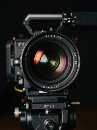 Cinematic close-up of an anamorphic lens with subtle neon reflections, professional camera equipment, low-key dramatic lighting, dark background, 35mm, portrait aspect.