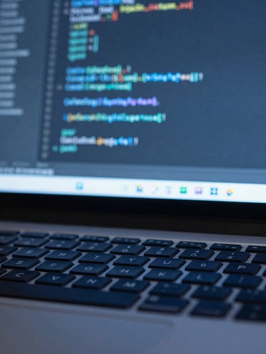 Macro shot of clean IDE code on a high-resolution screen, soft blue ambient light reflecting on a dark keyboard, cool editorial technology photography