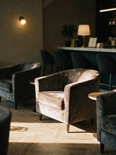 Cinematic 35mm photograph of a moody boutique hotel lobby at golden hour, soft light hitting velvet armchairs, shadows stretching across herringbone floors.