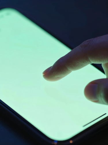 Macro photograph of fingers interacting with a high-contrast mobile app interface, vibrant neon mint green highlights, dramatic dark studio setting, shallow depth of field, sleek glass reflections.
