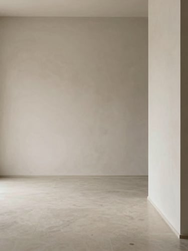 Minimalist editorial photography of a quiet, sophisticated architectural space with soft diffused natural light, muted slate and warm ivory tones, shallow depth of field, 35mm