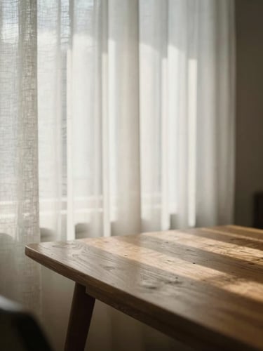 A quiet, sunlit room with a wooden table, soft morning light filtering through linen curtains, creating a sense of calm and balance.