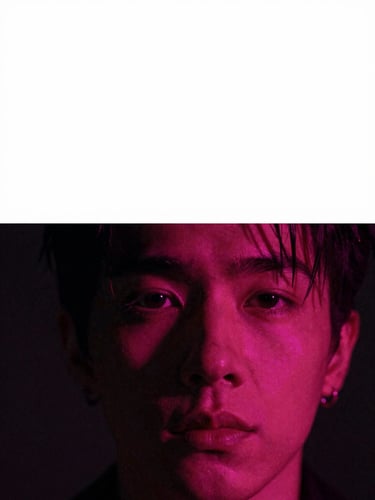 Close-up frame from a music video: a performer's face half-submerged in deep magenta light, left side swallowed by shadow, saturated gel color raking from screen-right, film grain visible, composition-first crop with generous negative space above