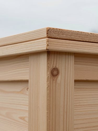 Macro close-up of dense, light-toned Baltic timber grain, soft overcast natural light, shallow depth of field, showcasing pristine architectural joinery.