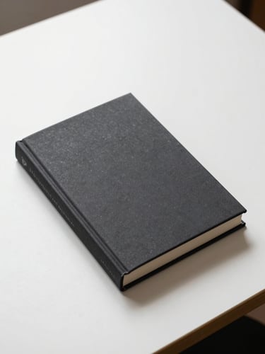 Overhead flat-lay of a closed hardcover non-fiction book on a clean white desk, crisp studio light, no title visible