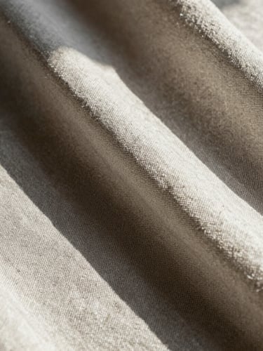 Macro extreme close-up of heavy linen fabric drape, raw edge details, high-contrast midday Florida sun casting sharp geometric shadows