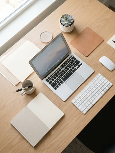 Overhead flat-lay of an impeccably organized desk with neat folders, a laptop, and a clean keyboard in bright natural daylight, 35mm