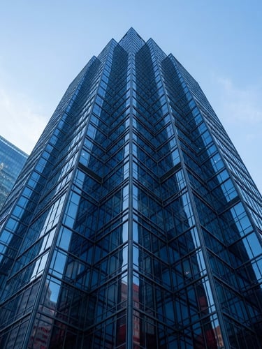 Crisp architectural photography of the geometric glass and steel facade of a modern skyscraper in Toronto, cool morning daylight, deep blue reflections, no people, 35mm lens