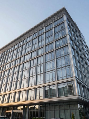 Wide angle architectural rendering of a modern hospital facade with clean glass and steel, cool morning daylight, sharp silver-metallic reflections.