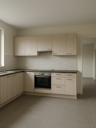 Wide environmental shot inside an empty modern kitchen, neutral daylight through large windows, full room depth visible from corner angle showing countertops cabinetry and open doorway beyond, no people no staging props