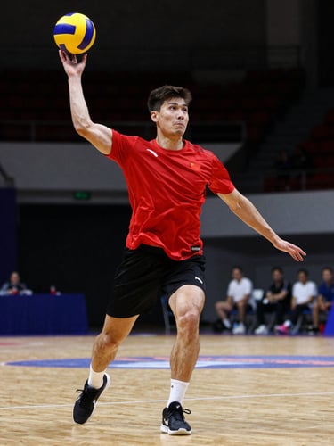 Dynamic low-angle action shot of a dodgeball player mid-throw in an indoor sports arena, intense facial expression, dramatic high-contrast lighting, shallow depth of field.