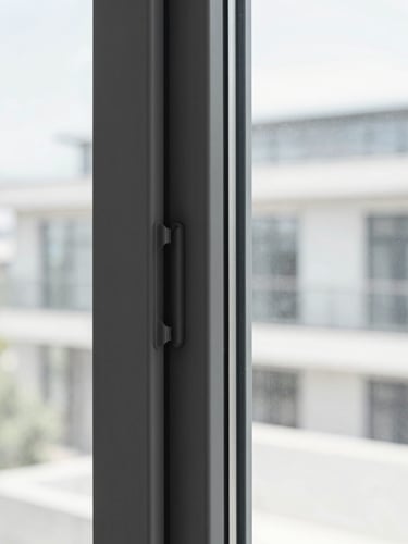 Sleek dark grey PVC window frame detail with double rubber gaskets, looking out to a soft-focus clean modern city, bright architectural daylight, cool desaturated tones, sharp focus, 35mm