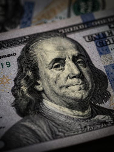 Macro shot of a security watermark on official financial paper, dramatic low-key side-lighting with deep shadows, desaturated slate tones, 35mm lens