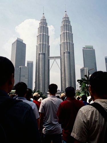 Raw photojournalism, a wide-angle documentary shot of a crowded public assembly in Kuala Lumpur, high-contrast natural light, dramatic shadows, gritty 35mm film grain.