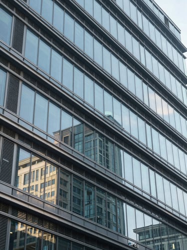 Cool architectural lines of a corporate headquarters, glass and steel facade, clinical morning light, sharp geometric angles.