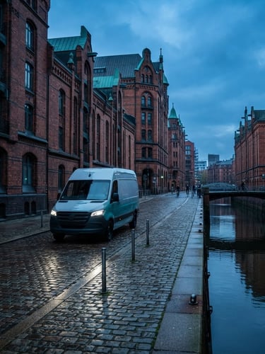 Modern, sleek NoonMove delivery van driving through a historic street in Hamburg's Speicherstadt at dawn, crisp light, dynamic wide-angle shot, deep blue and turquoise tones.