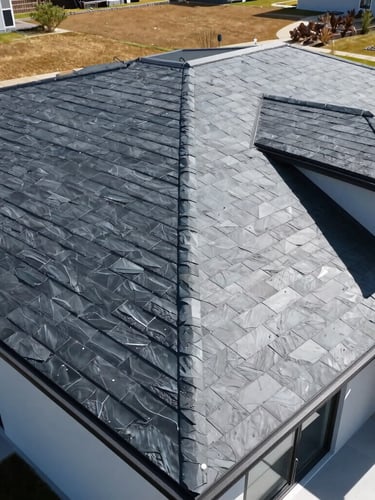Wide-angle drone shot of a flawless newly installed dark slate roof on a modern home, bright post-storm daylight, high-contrast, clean architectural lines.