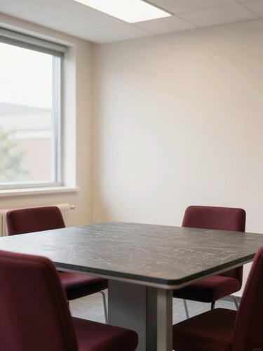 A clean modern academy interior with soft beige walls, a professional slate-topped training desk, bright natural diffused daylight, 35mm editorial photography