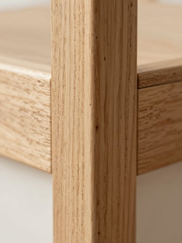 Macro close-up of a premium light oak wood frame corner joint, showing natural grain texture, soft daylight, shallow depth of field