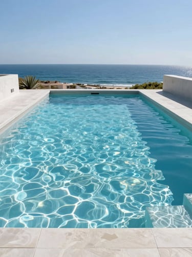 Bright architectural photography of a luxurious modern concrete pool with crystal clear water, sunny daylight, clean lines, coastal background