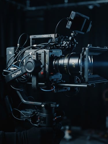 Anamorphic close-up of a high-end cinema camera rig on a stabilized gimbal, moody low-key studio lighting with cool blue rim light, deep shadows, cinematic film texture.