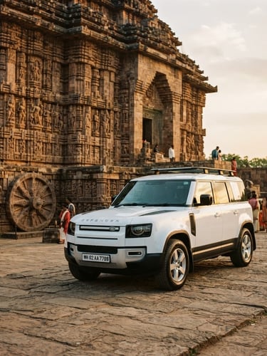 A clean, modern white SUV parked near the ancient stone carvings of Konark Sun Temple, soft golden-hour sunlight reflecting on the polished car hood, warm editorial travel photography, wide-angle lens, 35mm film look.