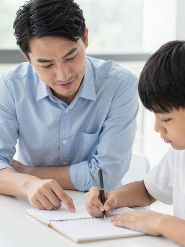Bright editorial photography of a tutor guiding a student over a notebook, soft natural daylight, clean blue and white tones, shallow depth of field, 35mm
